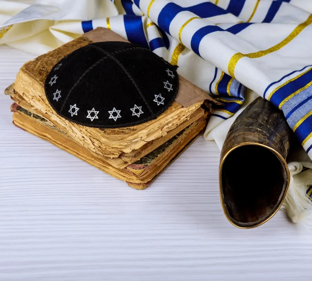 Hebrew handwritten Torah, on a synagogue alter, with Kippah and Talith shofar ram's horn
